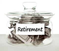 A jar labeled retirement and filled with dollar bills