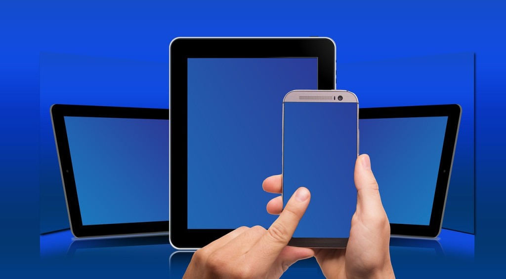Three different devices with touch screens: large and small tablets and a smart phone.