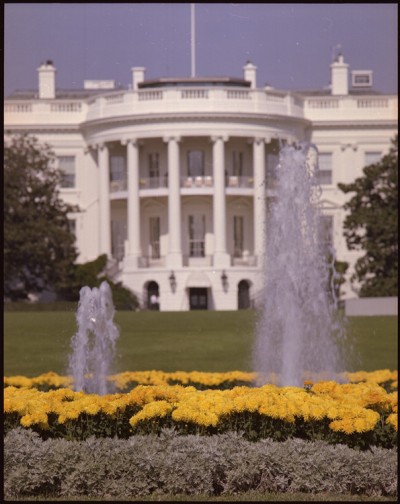 The White House and the fountains and gardens in front of it are shown.