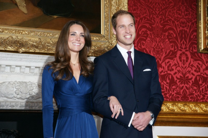 Prince William is shown holding wife Catherine Middleton’s hand.