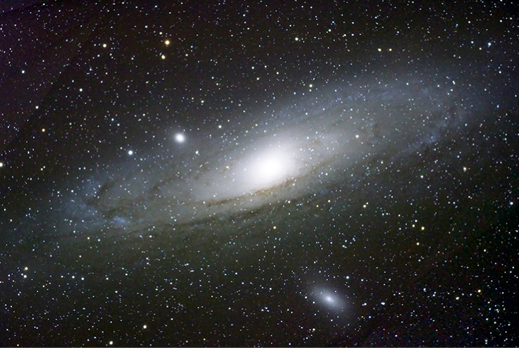 A photograph of the Andromeda galaxy is shown.