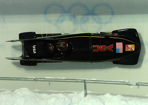 A photograph of a bobsled on a track at the Olympics.