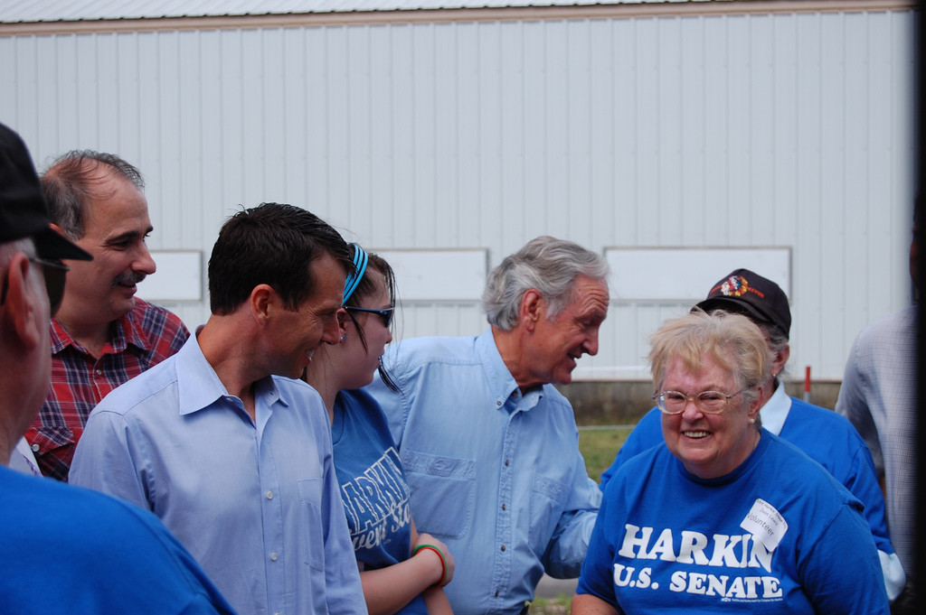Photo showing a group of campaign workers, wearing blue shirts that read 