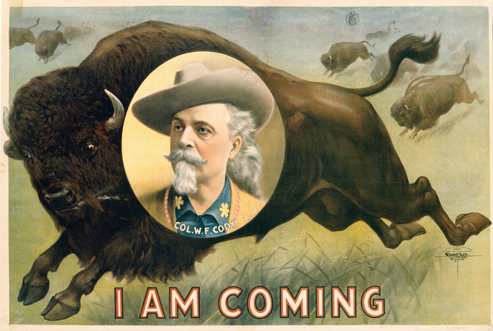 Portrait of Buffalo Bill in front of a buffalo with the words I Am Coming.