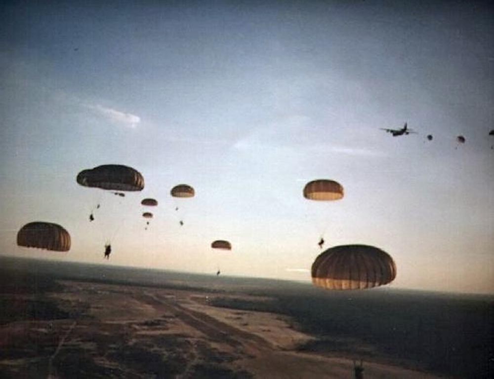 Parachuters coming out of a plane.