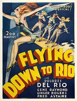 A movie poster for Flying Down to Rio shows drawings of four young women in short dresses, with their arms spread out in various poses. The text reads, “Stupendous musical! 200 Beauties! Flying Down to Rio with Dolores del Rio, Gene Raymond, Ginger Rogers, Fred Astaire.”