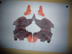 Rorschach image with black and red smudges
