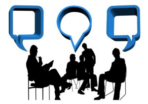 Graphic of people sitting and talking with thought and conversation bubbles, indicating a conversation.