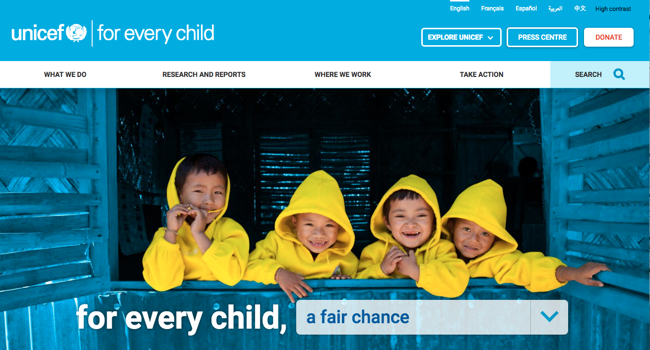 Four boys in yellow coats looking out the window of a blue building on Unicef's homepage. The slogan reads, 