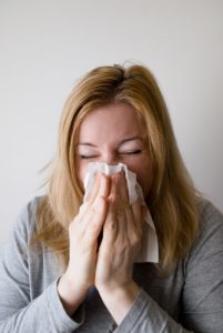 Woman holding a handkerchief to her nose