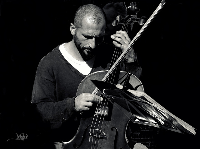 Black and white photo of a male cello player