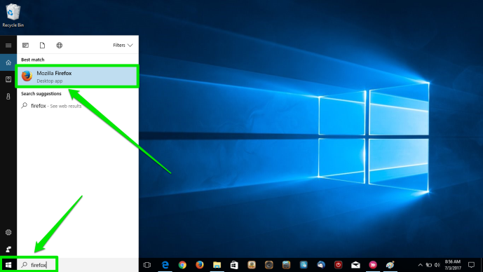 The desktop of a Windows 10 is displayed. There are two green arrows pointing at the windows button on the desktop as well as the search box. The second arrow is pointing at the Mozilla Firefox icon in the newly opened menu.