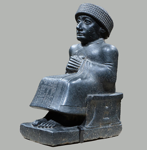 A stylized statue made of black stone.