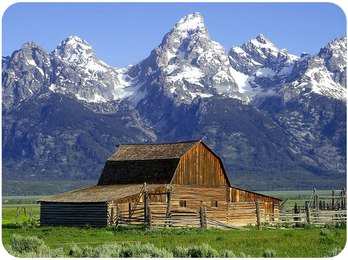 A barn in front of the Teton Mountains