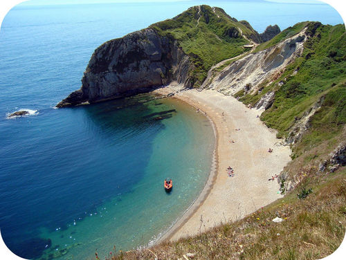 A crescent-shaped beach surrounded by tall hills