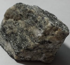 A light mineral with dark shiny streaks