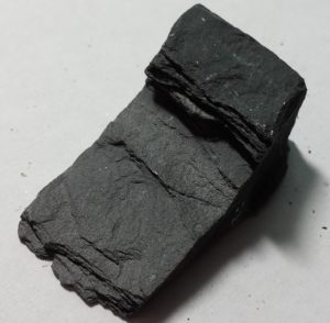 A dark black mineral that can be broken into sheets