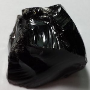A shiny, smooth, pure black mineral