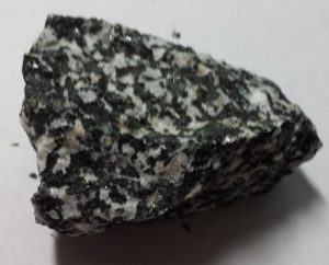 A mineral with a mottled color pattern of dark gray and white