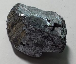 A shiny, dark gray mineral