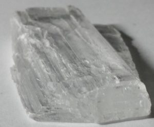 A translucent mineral with straight cleavage marks