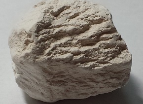 A rough-textured, uniformly light colored mineral