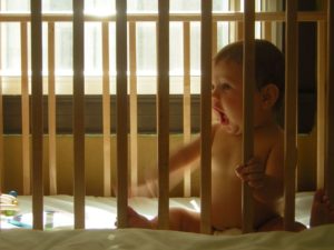 Photo of a baby in a crib.