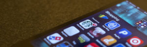 Photo of a smartphone screen, showing a screenful of online shopping options (e.g., Starbucks, Dominoes Pizza, etc.).