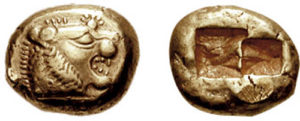 Image shows front and back side of an electrum coin from Lydia, 6th century BCE. Front has a lion head; reverse has two square imprints, probably to standardize the coin's weight.