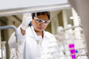 A chemist studies a sample of textile dye.