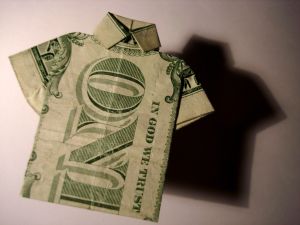 dollar bill folded to resemble a shirt