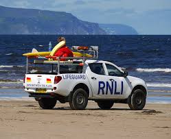 Photo of a life guard pickup truck on the beach.