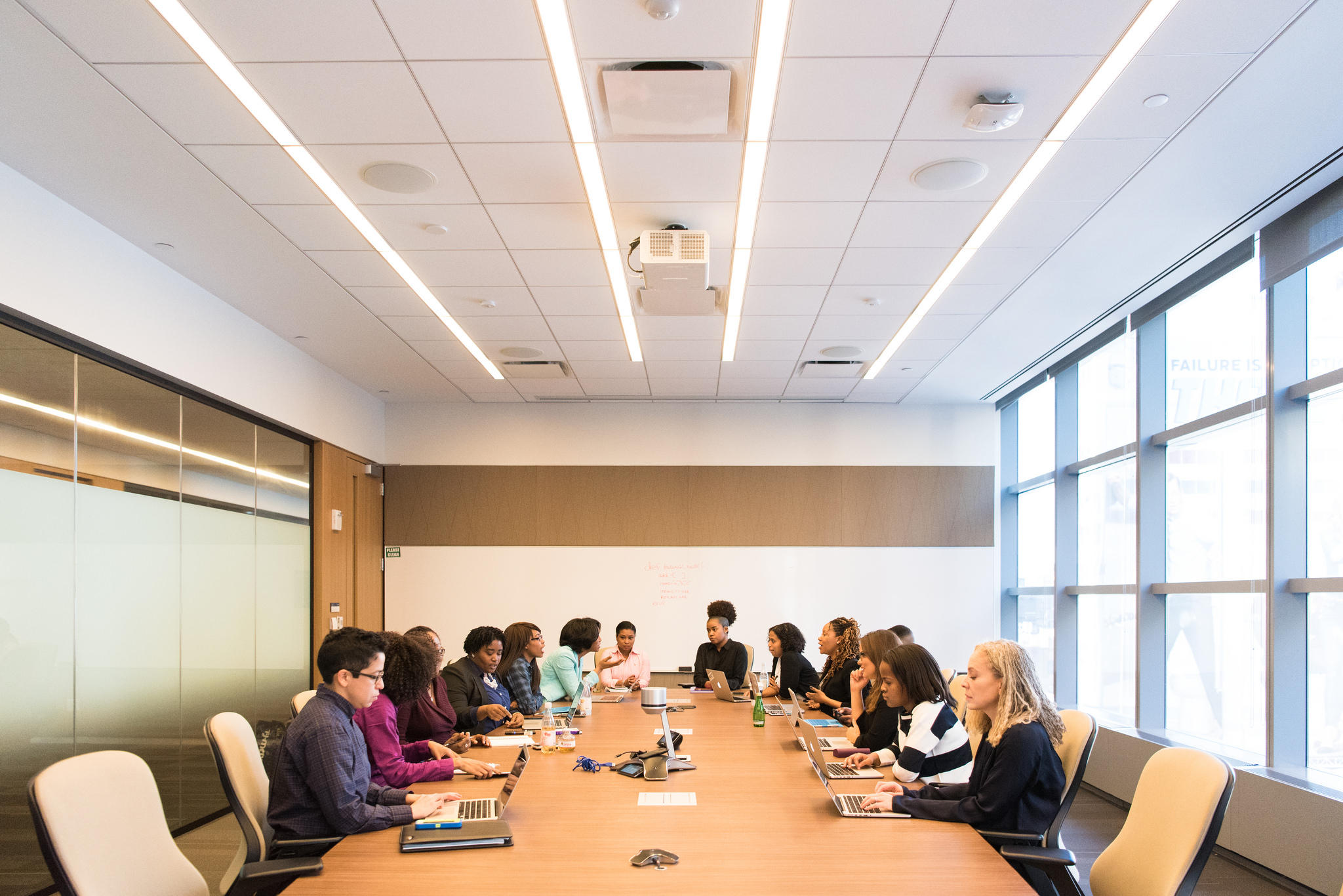A group of people hold a meeting in a conference room.