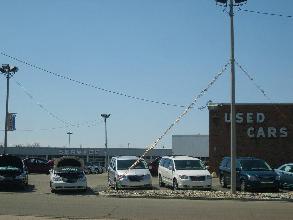 Photograph of several cars in a used car lot