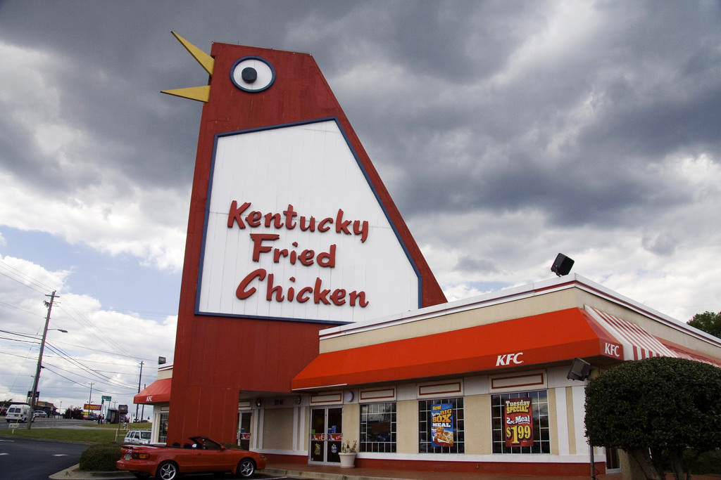 Photo of a KFC restaurant in Georgia. Part of the building resembles a big red chicken.
