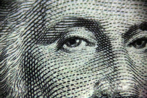 Close up image of George Washington's face on the 1 dollar bill