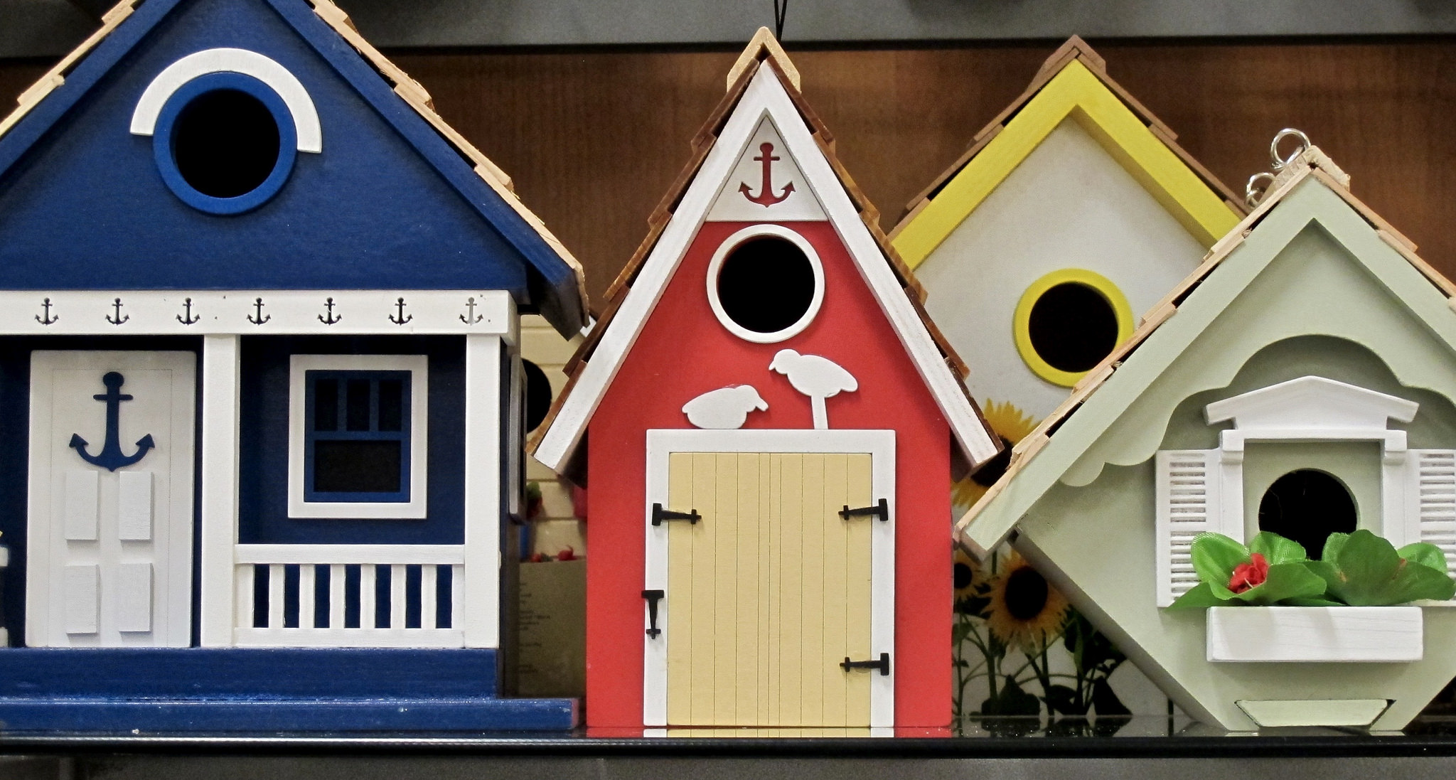 Three different, ornate, brightly colored birdhouses.