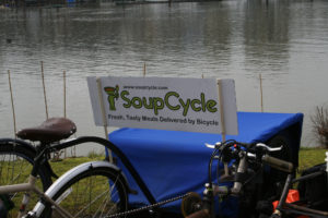 Photo of a bicycle with carrier on the back and an add for the business,