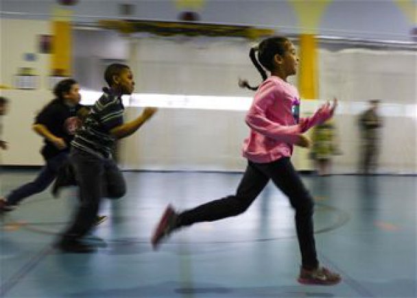 Children running in a gym.