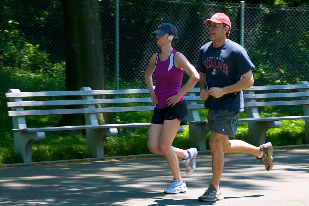 Man and woman in athletic clothes going for a jog.