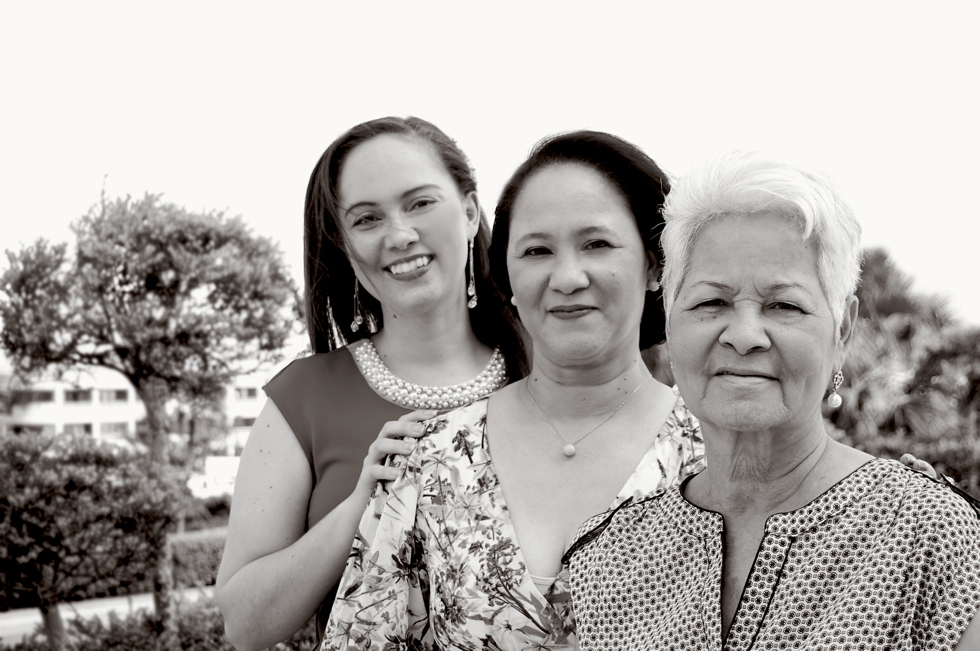 Three generations of women in a family: young adult, middle-aged mother, and older grandmother.