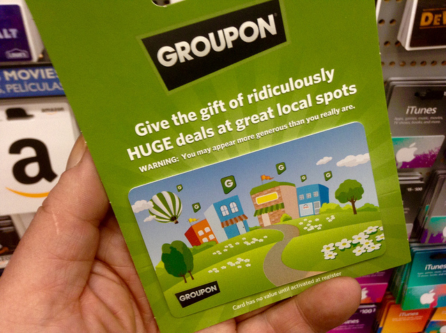 Image showing a Groupon gift card help in someone's hand.