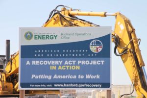 Construction equipment and a sign for the Recovery Act-funded work at the Hanford site.