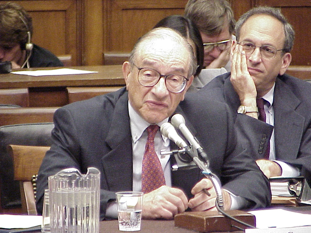 Alan Greenspan, seated at a table testifying before the House Financial Services Committee.