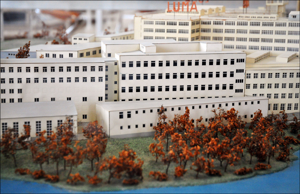 Architectural model of the Luma factory, a large white series of connected buildings with many rows of small square windows.