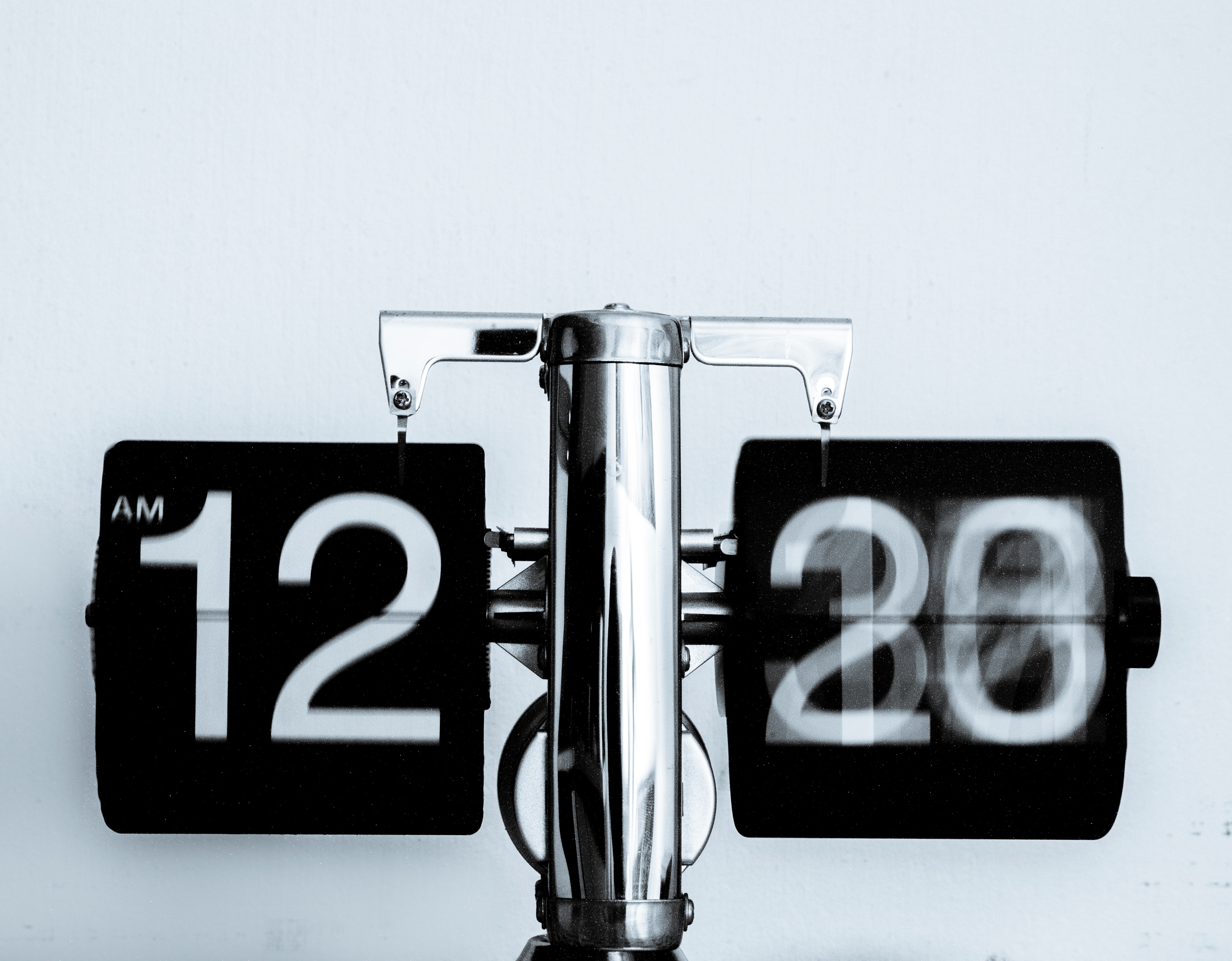 Time-lapse photo of a clock showing the minutes changing.