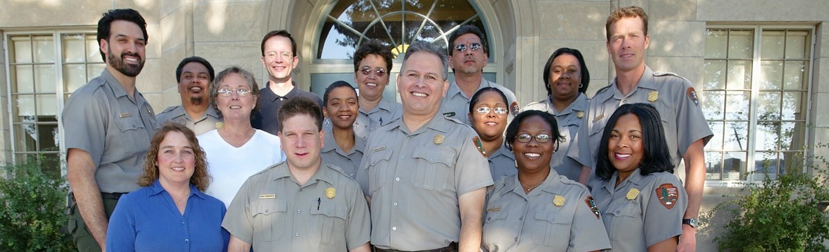 Photograph of the team working at Harpers Ferry National Park. The individuals have differing racial backgrounds (including white, black, and latino). They also differ in gender and age.