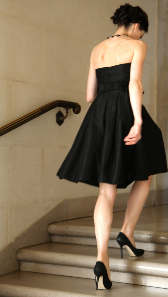 A woman wearing a cocktail dress and heels.