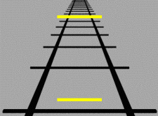 Lines of a railroad track as they converge off into the distance. One yellow line is close to the front of the image on the tracks and another line of the same size is placed towards the back of the image along the tracks. Because of the converging lines, the yellow line in the back appears larger than the line in the foreground.