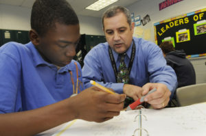 Eight grade student Caribe Polk gets some assistance from Chris Shumway, math teacher, at Feagin Mill Middle School Nov. 7. 